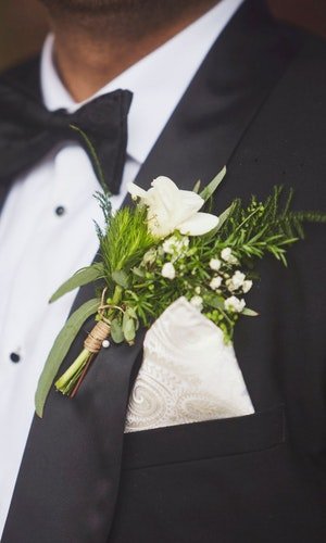 A seasonal buttonhole of cornflowers and foliage