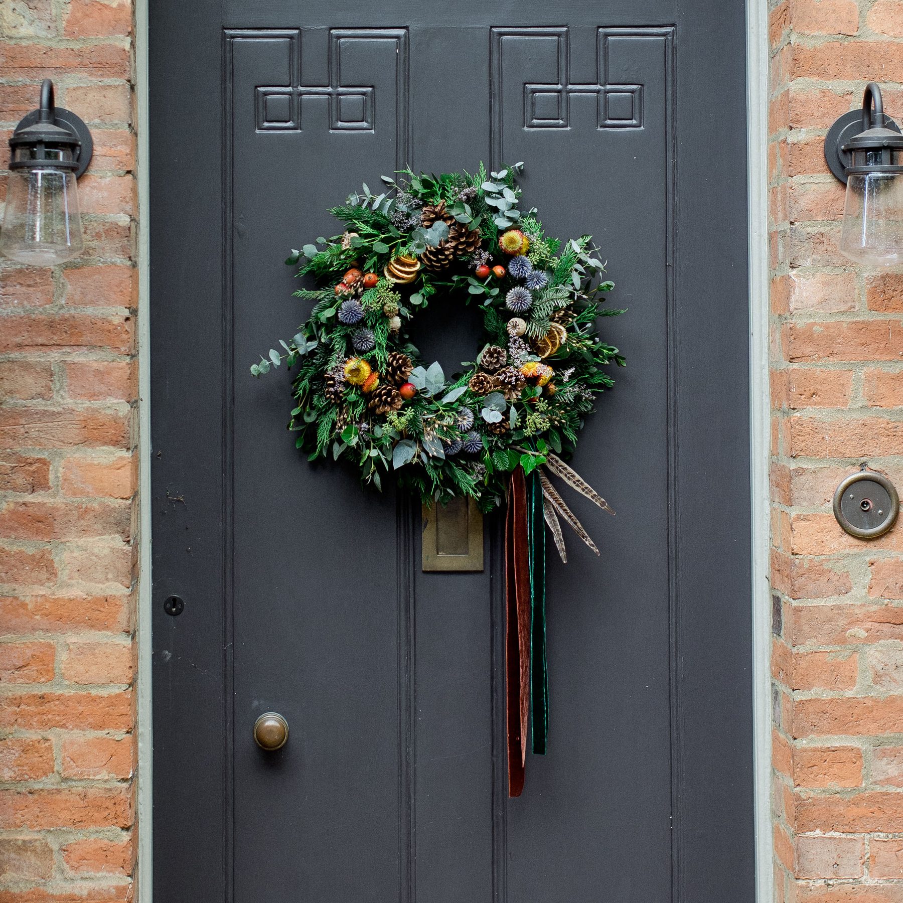 Hand-made compostable Christmas wreath on a country door, by Field Gate Flowers
