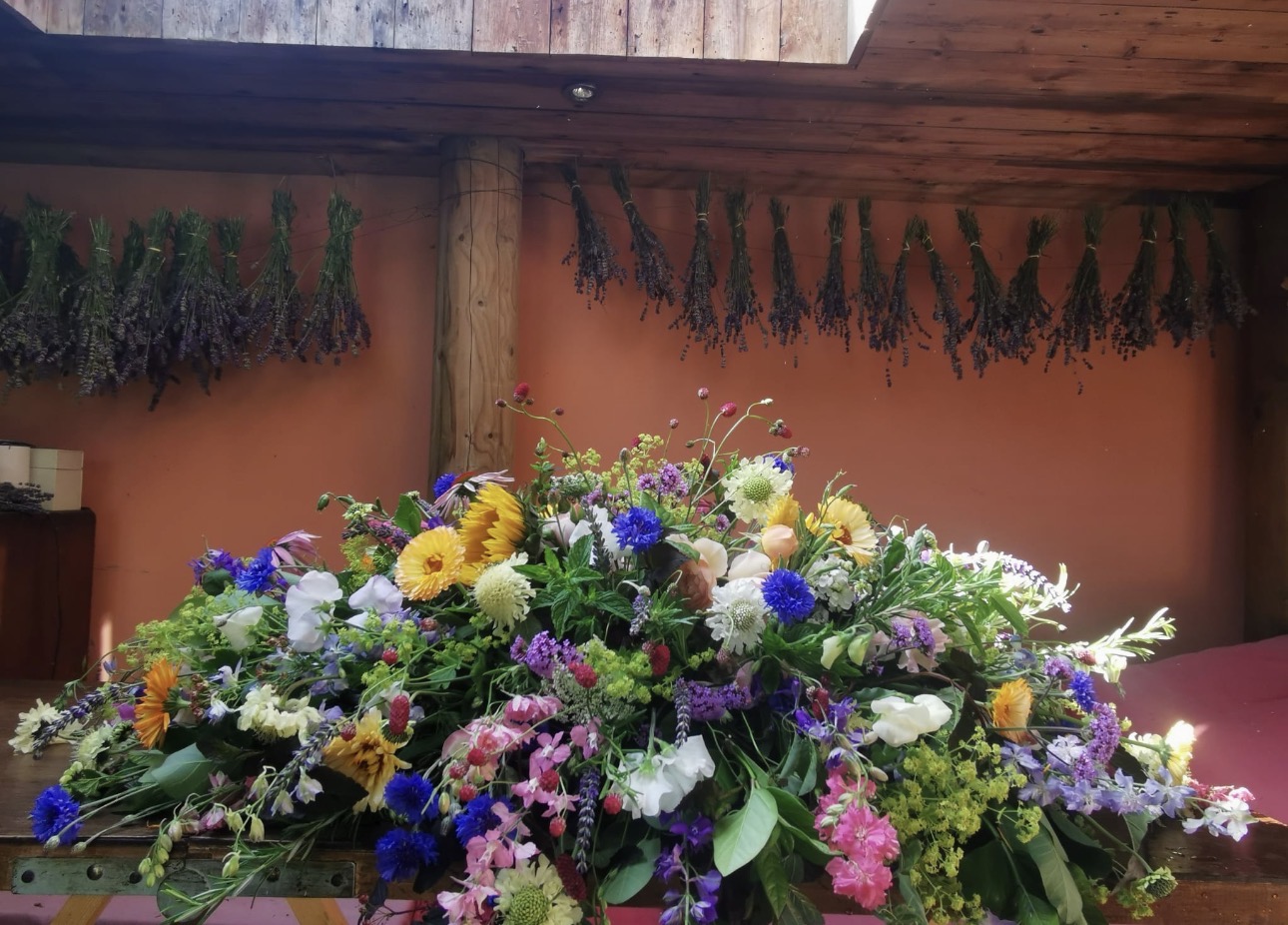 A hand-tied funeral sheath by Field Gate Flowers